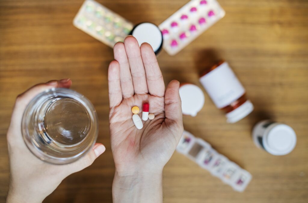 Woman taking medication for her illness